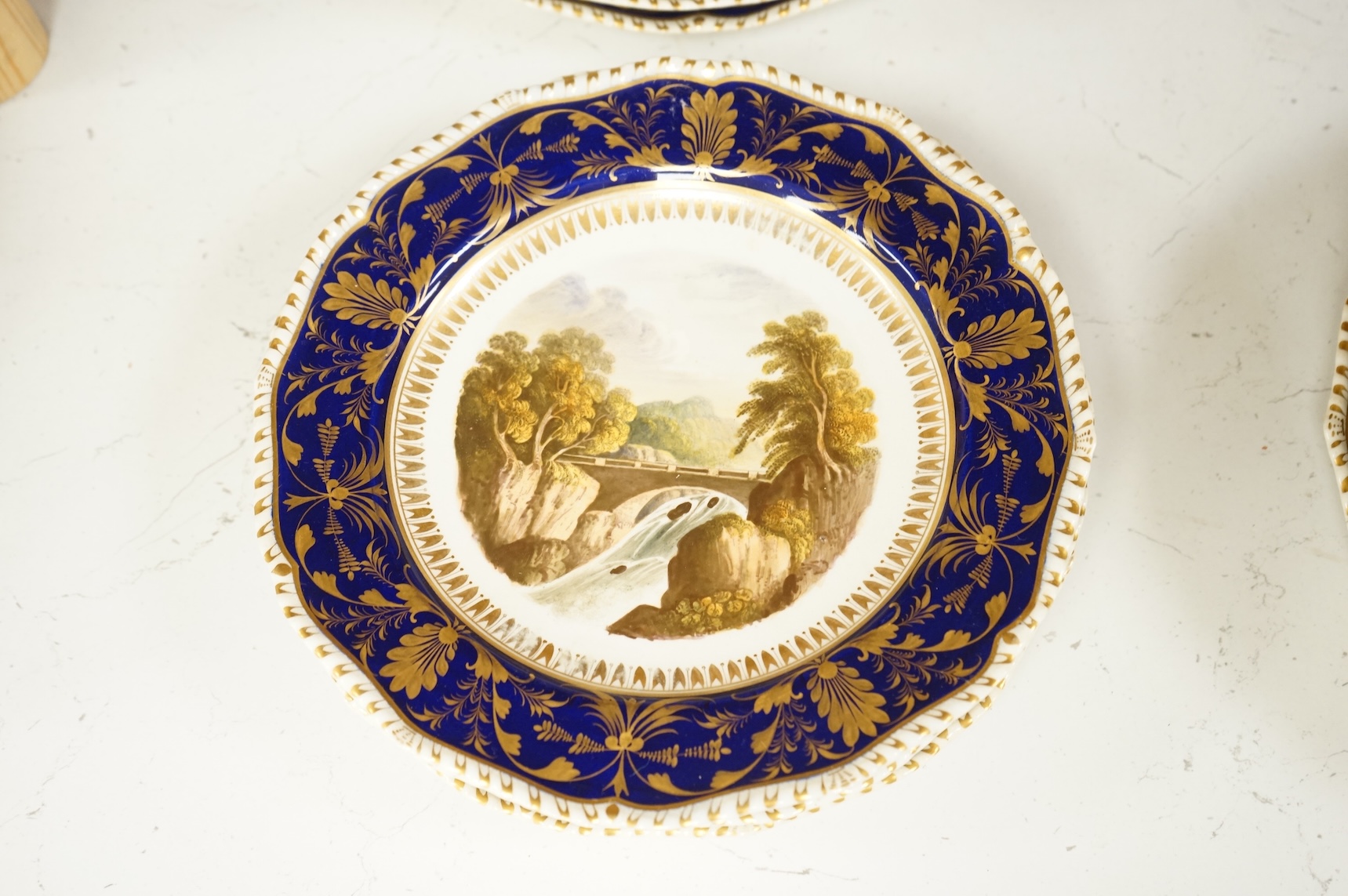 A Bloor Derby titled view part dessert service, c.1820 to include View on the Wye and View in Yorkshire, largest 29cm wide (16)